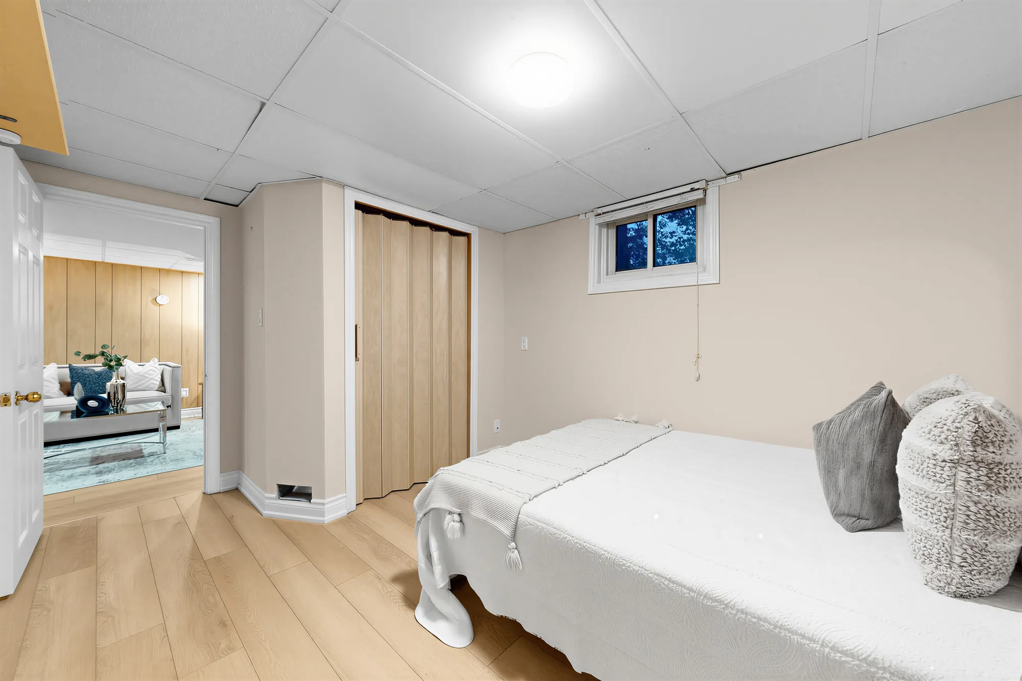 The same bedroom toward its folding closet door and the doorway to the family room
