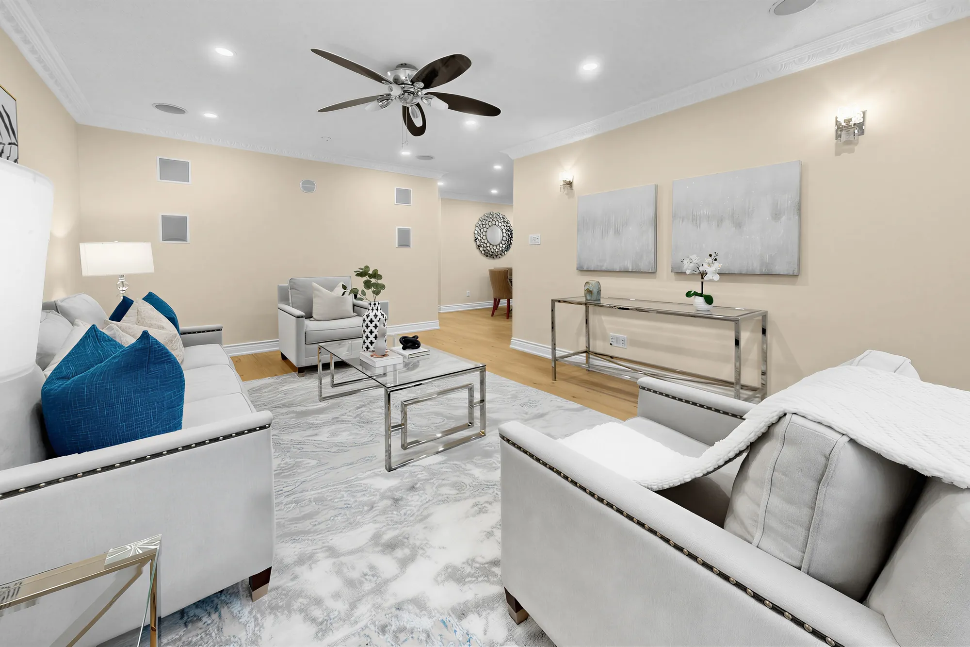 The living room toward the dining room, a glass console table, the sofa at the left
